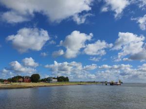 a large body of water with a blue sky with clouds at Wallaby-1-2-Personen in Brunsbüttel