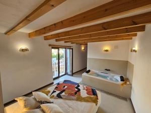 a bedroom with a large bed and a tub at Apartamentos Rurales LA BUENA ESTRELLA in Alcalá del Júcar