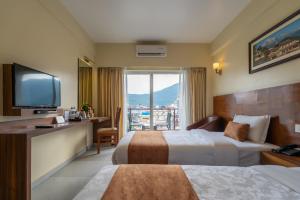 Rúm í herbergi á Hotel Haven O' Ganga