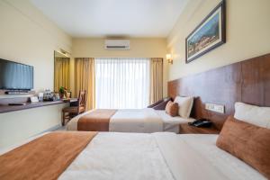Rúm í herbergi á Hotel Haven O' Ganga