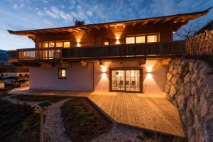 a house with a balcony on the side of it at Chalet Wegmacher in Kirchberg in Tirol