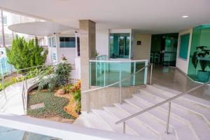 a view of a building with stairs and a garden at Bacutia, prédio frente ao mar! in Guarapari