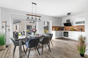 a kitchen and dining room with a table and chairs at Ferienhaus Donnerkeil Fehmarn in Fehmarn
