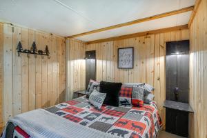 a bedroom with a bed in a wooden wall at Island Park Vacation Rental about 31 Mi to Yellowstone in Island Park