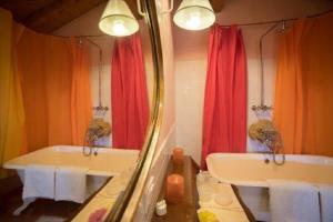 a bathroom with two sinks and a mirror at Romantic Nido in Verbania