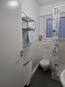 a white bathroom with a toilet and a sink at Charmante Ferienwohnung in Herne-Mitte in Herne