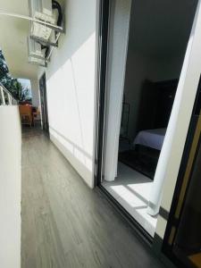 a room with a sliding glass door leading to a bedroom at 3-Bedroom Apt with Oceanviews, 1min Walk to Beach - NYHA2 in Flic-en-Flac