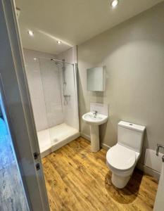 a bathroom with a toilet and a sink at Private room - Shared Bathroom, Wakefield in Wakefield
