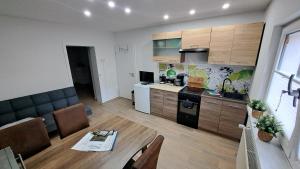 a kitchen and a living room with a table in a room at Gästehaus Ehrhardt in Merseburg