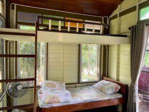 a bedroom with a bunk bed in a house at Croc Camp in Lat Krabang