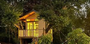 a small house with a balcony on a tree at Croc Camp in Lat Krabang