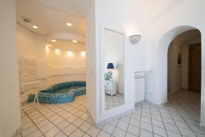 a bathroom with a tub in the middle of a room at Relais Bijoux Ischia in Ischia