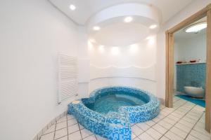 a bathroom with a large blue tub in a room at Relais Bijoux Ischia in Ischia