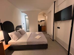 a bedroom with a bed and a flat screen tv at Apartment Falirou in Athens