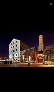 a large brick building with a tall tower at night at 2BR Downtown Apartment in Toronto Close to Eaton Centre in Toronto