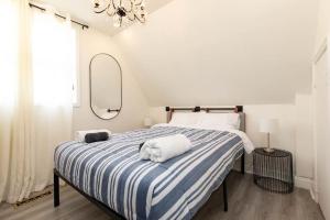 a bedroom with a bed with a blue and white striped blanket at 2BR Downtown Apartment in Toronto Close to Eaton Centre in Toronto