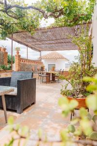 a patio with a couch and a table and chairs at Casa Froscar in Bermejo