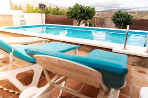 a pool with chairs and a swimming pool at Casa Froscar in Bermejo