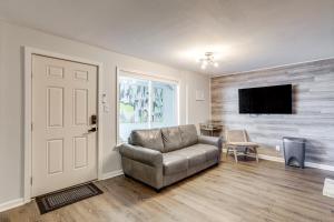 a living room with a couch and a flat screen tv at Wildwood Condo Community Pool, Walk to Beach! in Wildwood