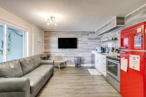 a living room with a couch and a red refrigerator at Wildwood Condo Community Pool, Walk to Beach! in Wildwood