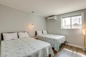 a bedroom with two beds and a window at Wildwood Condo Community Pool, Walk to Beach! in Wildwood