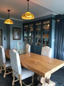 a dining room with a wooden table and chairs at Seagulls Boutique Lodgings in Mevagissey
