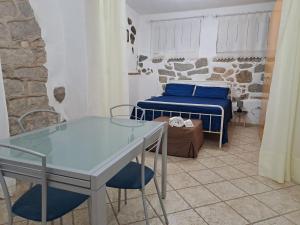 a bedroom with a bed and a table in a room at Tempesta Home in Lanusei