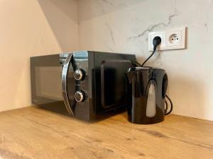 a microwave sitting on a counter next to a coffee pot at Apartmán Strážske s balkónom in Michalovce