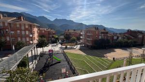 a playground in a city with mountains in the background at Apartament reformat al Berguedà 6p in Sant Jordi de Cercs
