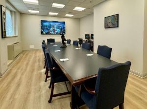 a conference room with a large table and chairs at The GEM Museum Suites in Evanston