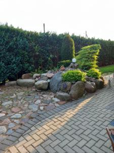 a garden with a bunch of rocks and plants at Green Garden Apartments in Kaunas