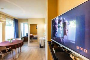 a living room with a flat screen tv on a wall at Villa De Keyser in Eeklo