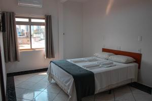 a bedroom with a bed in a room with a window at Hotel 15 de Julho in Foz do Iguaçu +52 photos