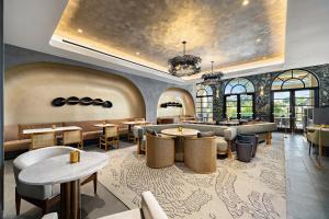 a restaurant with tables and chairs and windows at Grand Hyatt Indian Wells Resort & Villas in Indian Wells