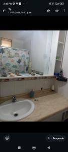 a bathroom with a sink and a mirror at Frente al Mar vista Panorámica Tomé in Tomé