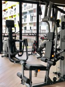 a gym with two tread machines in a building at Cozy and Sunny Apartment near to Mactan Cebu International Airport - Amani Grand Resort & Residences in Pusok