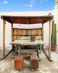a picnic table with a cactus and a table with luggage at Suite en Centro Historico Terraza, Wifi, Desk, AC in Querétaro +12 photos