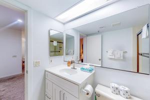 a white bathroom with a sink and a mirror at The Bridges 102 in Mammoth Lakes +95 photos