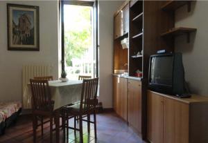 a living room with a table and a tv at La Terrazza di Spello in Spello