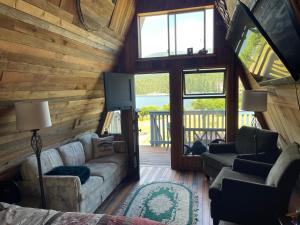 a living room with a couch and chairs in a cabin at Fishermans Folly in Lund
