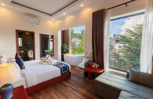 a bedroom with a tub and a bed and a couch at Green Villa Sapa in Sapa