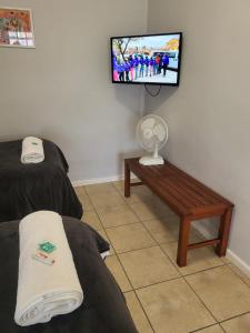 a room with a tv and a couch and a table at Lake Pleasant Hotel in Sedgefield