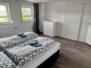 a bedroom with two beds with towels on them at Ferienwohnung Harz in Ballenstedt in Ballenstedt