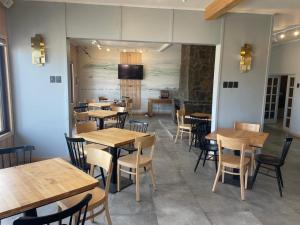 a dining room with wooden tables and chairs at Hotel Laraquete in Laraquete