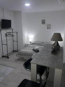 a room with two beds and a table with a lamp at VilaNatalija APARTMANI in Apatin