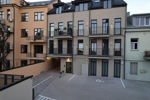 an empty parking lot in front of a building at Old Town - Bajor Studios - Self Check-in and Parking in Kaunas