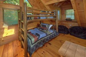 a bedroom with two bunk beds in a log cabin at Camp Cozy in Pigeon Forge