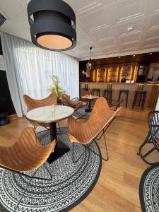 a lobby with tables and chairs and a bar at Hôtel Le Valois, Cognac Centre in Cognac +61 photos