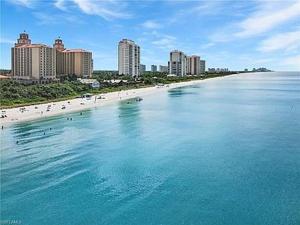 a view of a beach with buildings and the ocean at Near Beach Walk and Bike everywhere FENCED BACKYARD in Naples