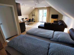 a living room with two beds and a couch at Ferienwohnung Zur Hohle in Niederreichenbach